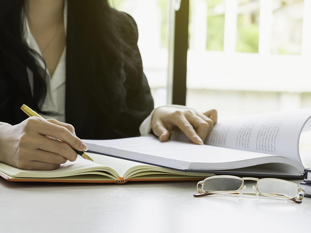 Lady Holding A Pen